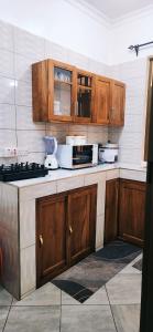 a kitchen with wooden cabinets and a counter top at chama haven apartments in Nkoanrua