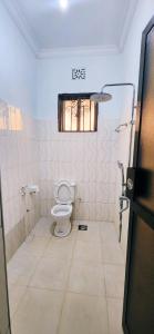 a bathroom with a toilet and a window in it at chama haven apartments in Nkoanrua +38 photos