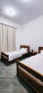 two beds in a room with at chama haven apartments in Nkoanrua