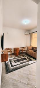 a living room with a table and a couch at chama haven apartments in Nkoanrua