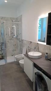 a bathroom with a toilet and a sink and a shower at B&B MAST Apartment Suite in San Pellegrino Terme +31 photos