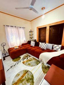 a living room with a large couch and a bed at The Mason Hideout in Watamu