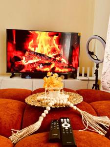a living room with a fireplace and a remote control at The Mason Hideout in Watamu