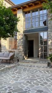 a patio with a bench and a balcony at Casa Limone - a due passi dal lago in Castelletto di Brenzone