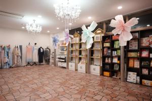 a store with a room filled with clothes on display at フルールリゾート&ホテル in Nishio