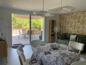a living room with a table and a couch at "Luci" proche du Zenith, Arténium Ceyrat, Auvergne, parking privé , in Beaumont