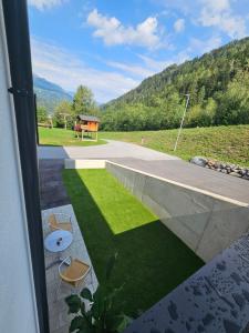 a view of a patio with chairs and grass at Apartment Warscher in Ainet