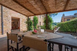 an outdoor dining table with chairs and a large wooden table at Il Lebbio Agriresort in Montaione