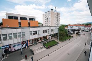 a city street with buildings and people walking on the street at Luxoria in Livno
