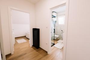 a room with a bathroom with a toilet and a mirror at Luxoria in Livno +8 photos