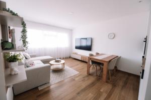a living room with a table and a couch at Luxoria in Livno