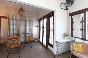 a living room with a couch and a table at Bisma Balcony Homestay in Yogyakarta