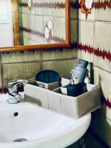 a bathroom sink with a tray on top of it at Moradia Vila Real Sto Antonio in Vila Real de Santo António
