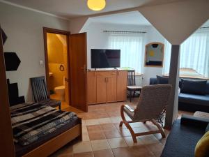 a bedroom with a bed and a living room at Willalux in Mielno