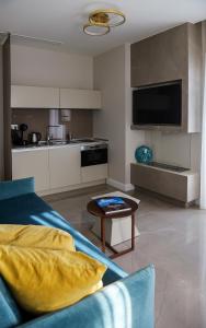 a living room with a couch and a table at L-Suites in Kavála