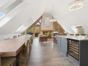 a kitchen with a long wooden table and chairs at The Penthouse - Uk52276 in Beccles