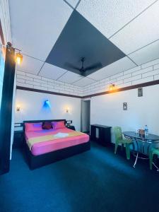 a bedroom with a large bed and a table at Linn View Home Stay Munnar in Munnar