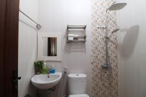 a bathroom with a toilet and a sink and a shower at Bisma Balcony Homestay in Yogyakarta +81 photos