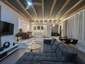 a living room with a blue couch and a table at Villa Velvet Chios in Chios