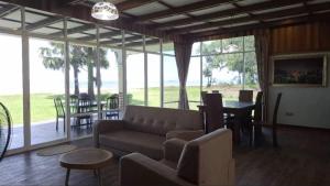 a living room with a couch and a table at Papar Beachfront View in Papar