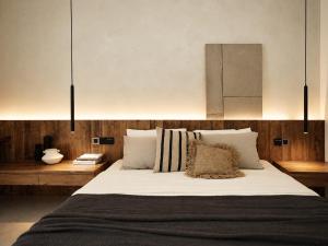 a bedroom with a large bed with white sheets and pillows at Banyan Villa Panglao with private pool in Panglao Island +24 photos