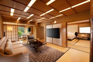 a living room with a couch and a television at Gajoen Tokyo in Tokyo