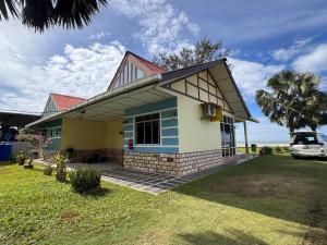 a small house with a car parked in front of it at Papar Beachfront View in Papar