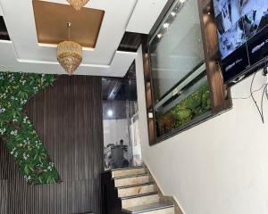 a staircase in a building with a plant on the wall at Hotel New bodhi inn in Gaya