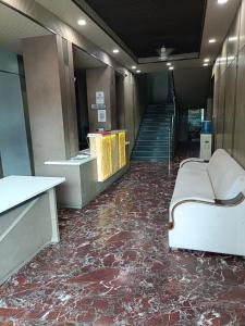 a room with a floor covered in red marble at Hotel Rahul Palace in Nagpur +9 photos
