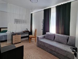 a living room with a couch and a bed at La Banel Hotel in Selemet +30 photos