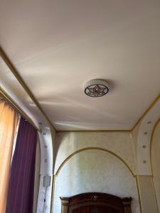 a ceiling with a light in a room at Приватні апартаменти in Odesa
