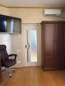 a room with a chair and a door with a window at Приватні апартаменти in Odesa