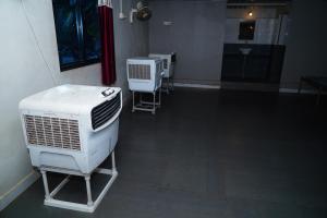 a room with two air conditioners on the floor at Kesar Villa Resort With Swimming Pool Sasan Gir in Sāsan Gīr