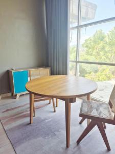 a wooden table in a room with a window at Kos Mama Ros in Labuan Bajo