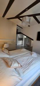 a large white bed with two pillows on it at Hotel Surselva in Chur