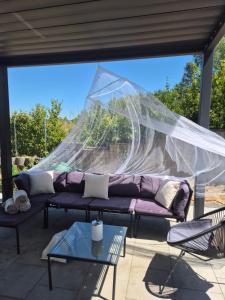 ein lila Sofa auf einer Terrasse mit einem Netz in der Unterkunft Big Loft in Empfingen