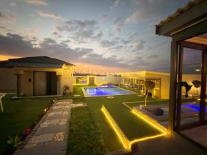 a backyard with a swimming pool and a house at Siyamthanda Boutique in Louis Trichardt