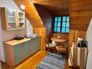 a kitchen with a sink and a table in a room at Võsula Tornimaja apartments in Võsu