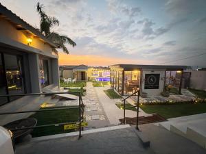 a house with a view of a backyard at dusk at Siyamthanda Boutique in Louis Trichardt