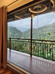 a balcony with a view of the mountains at Linn View Home Stay Munnar in Munnar