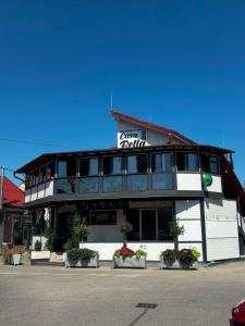 a building with a sign on the side of it at CASA BELLA in Ocna-Mureşului