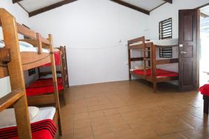 a room with several bunk beds in a room at Bluepango Guest House in Port Vila +51 photos
