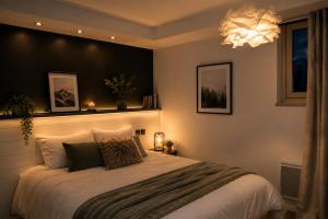 a bedroom with a large bed and a chandelier at Chalet Le Quartz in Val Thorens