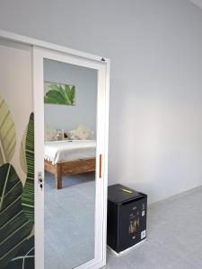 a door leading to a bedroom with a bed at Salt Resort & Spa in Amed