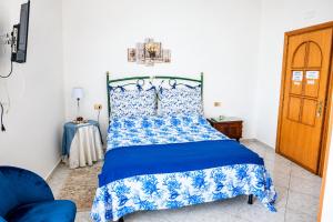 a bedroom with a blue bed with a blue and white bedspread at Villa Bianca in Tramonti +41 photos