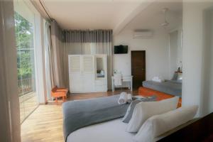 a bedroom with a bed and a living room at Villa Vajrapani in Kandy