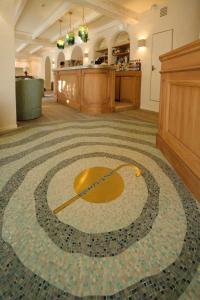a large room with a carpet with a target on the floor at Chez Gratien Hôtel Bistro Spa in Villeneuve-dʼAveyron +26 photos