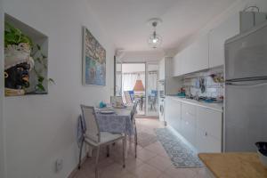 a kitchen with a table and a dining room at MARVELOUS CAPRI - Sea View Villa in Capri +34 photos