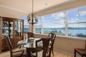 a dining room with a table and chairs and a window at Smirnoff Pointe Lakefront in Hollister