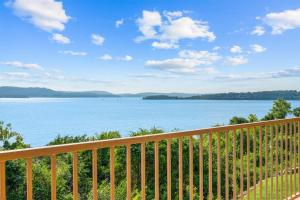 a balcony with a view of the water at Smirnoff Pointe Lakefront in Hollister